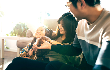 A family of three laughing together