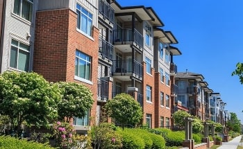 A side profile of a four-story apartment building