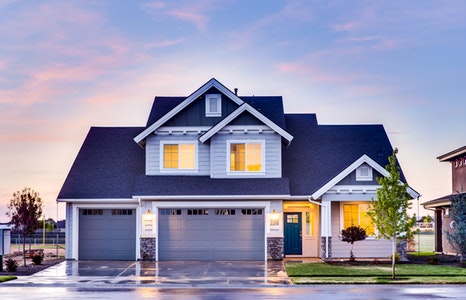 Portrait of a large blue house during a sunset