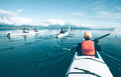 Three people kayaking on a lake